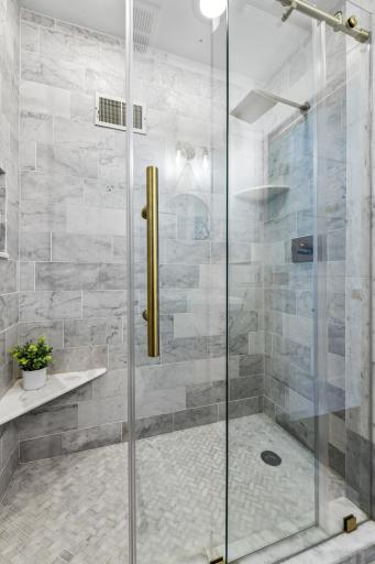 ...featuring beautiful marble finishes and custom shower door.
