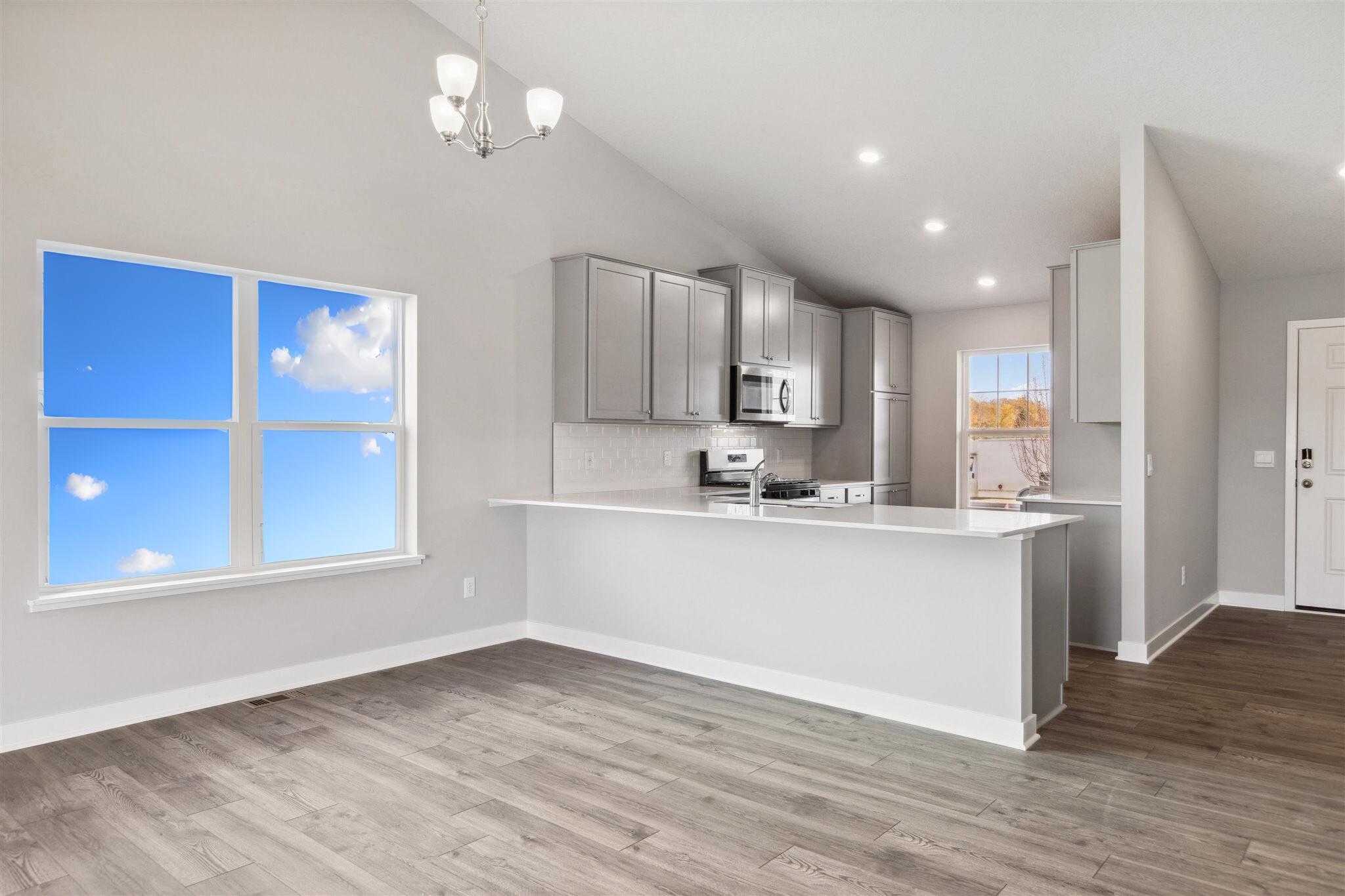 Bright and open with vaulted ceilings, the main level of the Rushmore is a sight to be seen! *Picture is of model home; actual finishes may vary.