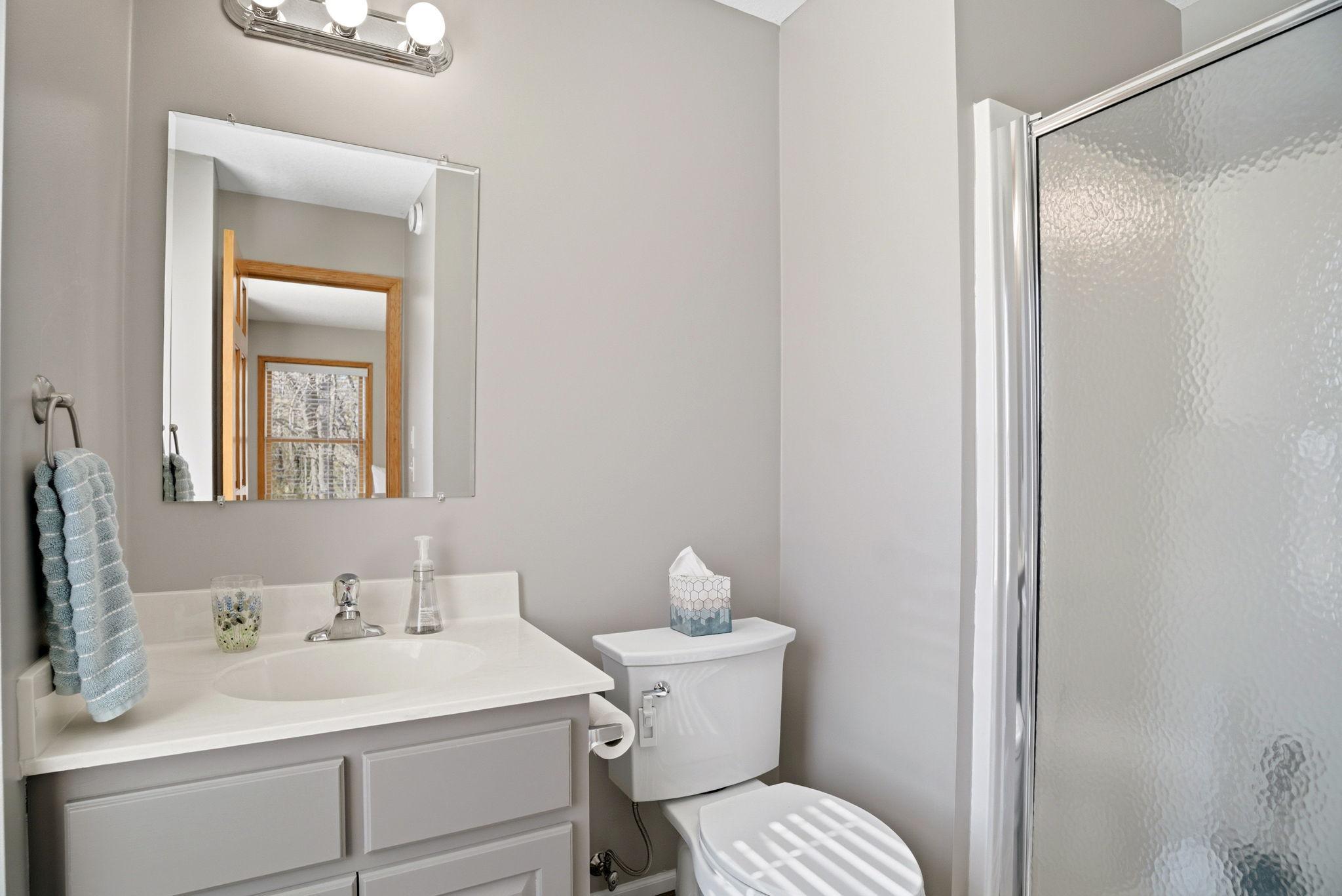 Upper-level third bedroom includes a private 3/4 bathroom, perfect for family or guests.