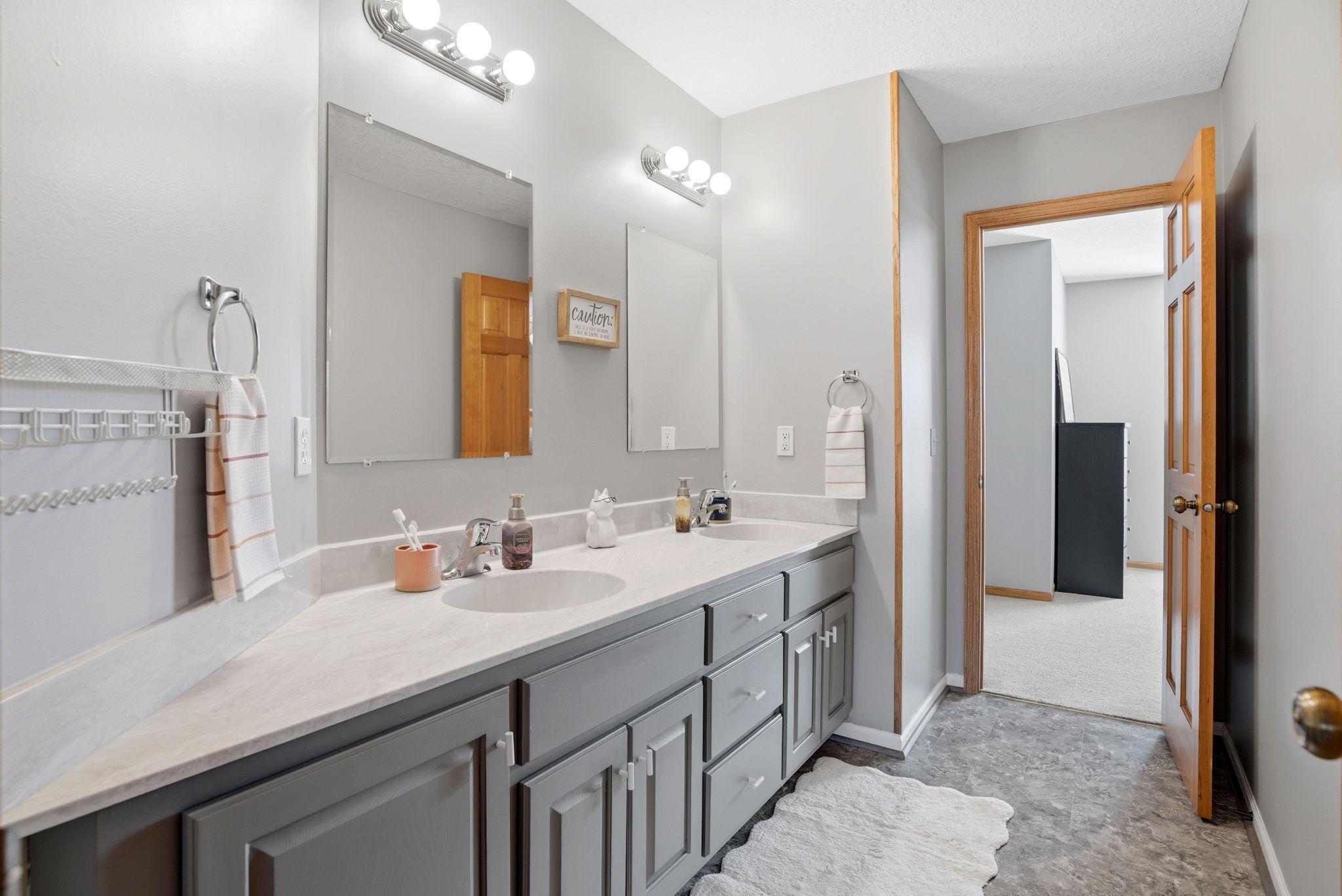 Full bathroom located between two upper-level bedrooms, featuring a separate space for the tub/shower combo and toilet for added privacy and convenience.