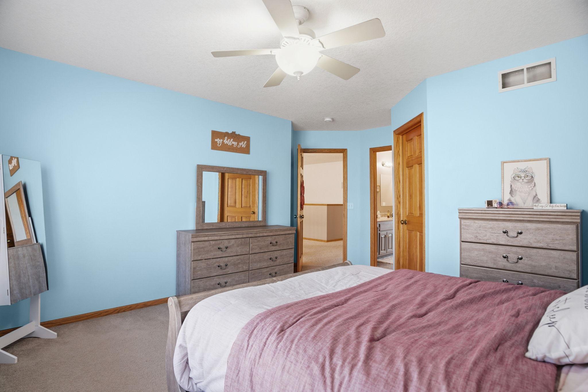 Expansive upper-level bedroom with a walk-in closet and a Jack-and-Jill bathroom, ideal for family living or guest accommodations.