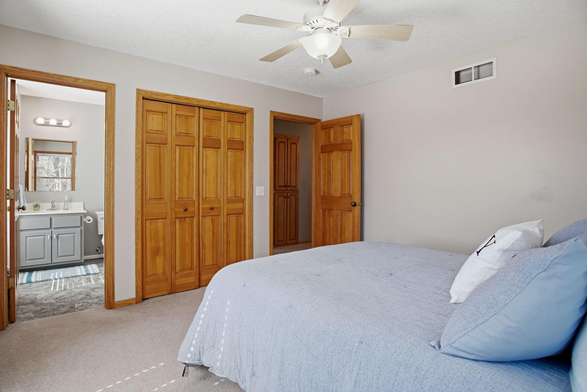 Upper-level third bedroom includes a private 3/4 bathroom, perfect for family or guests.