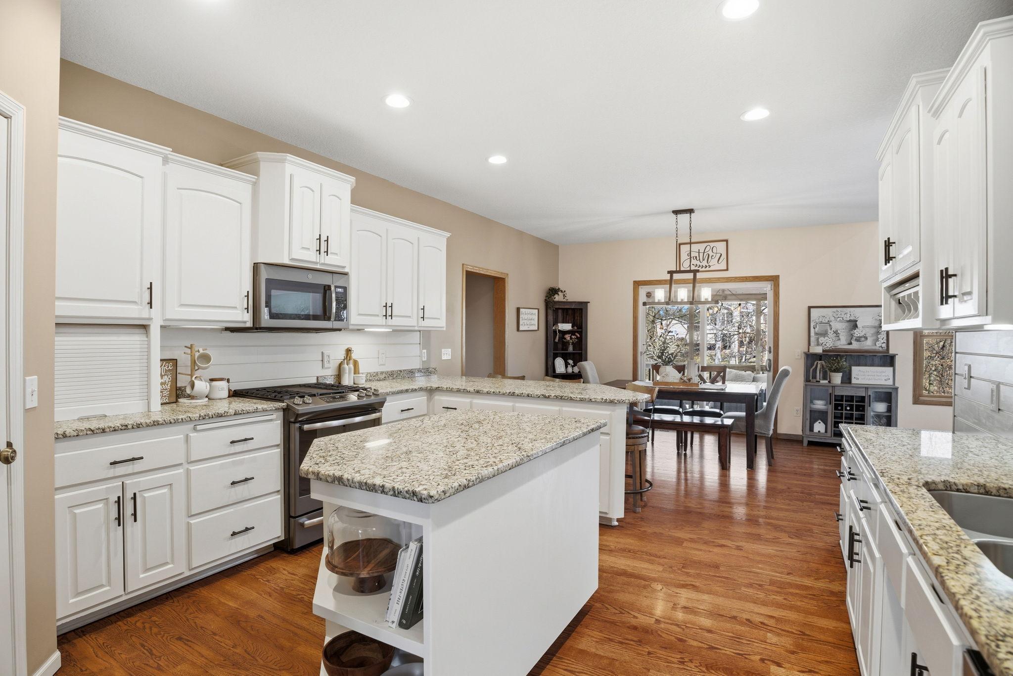 Well-appointed kitchen with an appliance garage, hardwood floors, granite countertops, and appliances upgraded in 2019.