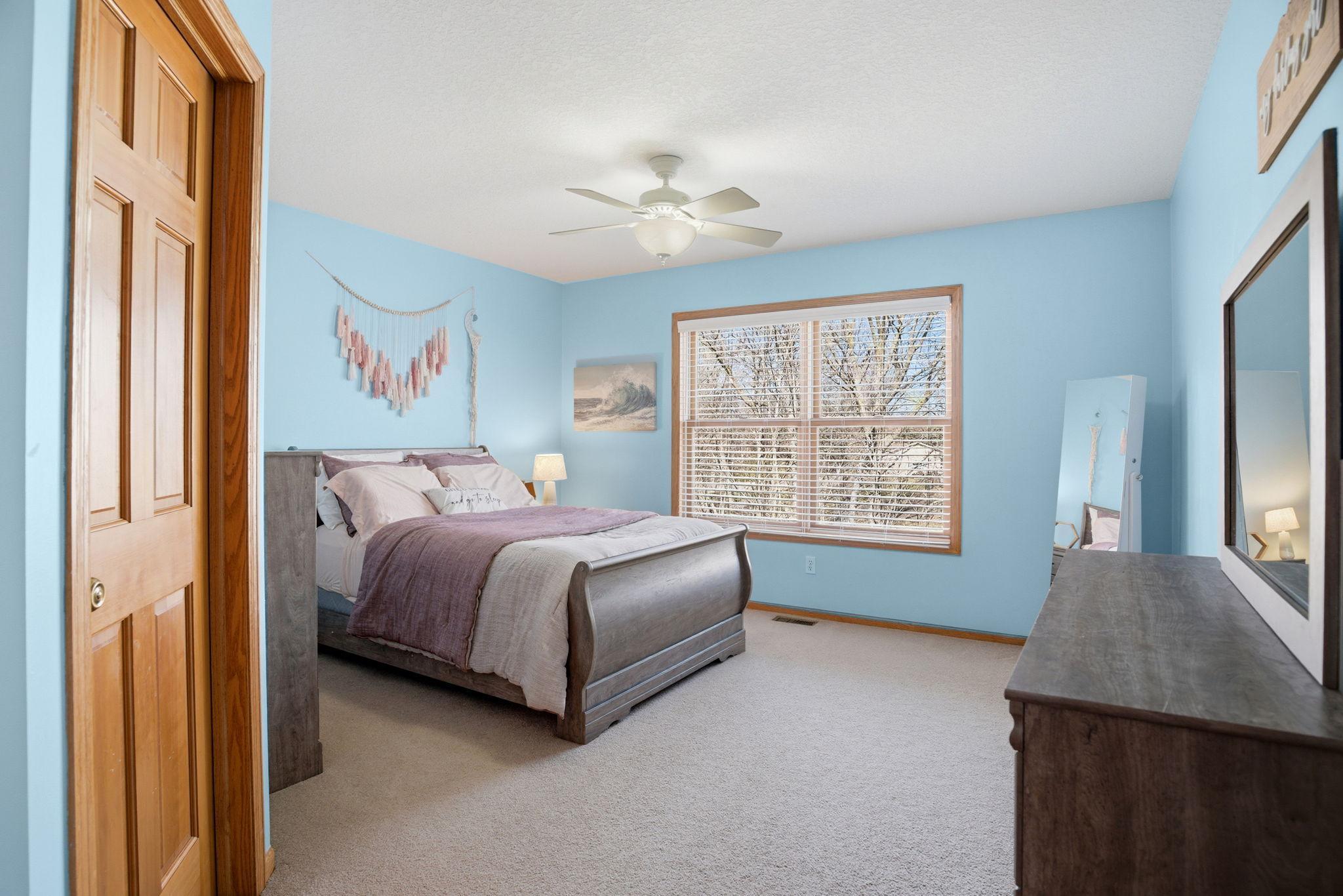 Expansive upper-level bedroom with a walk-in closet and a Jack-and-Jill bathroom, ideal for family living or guest accommodations.