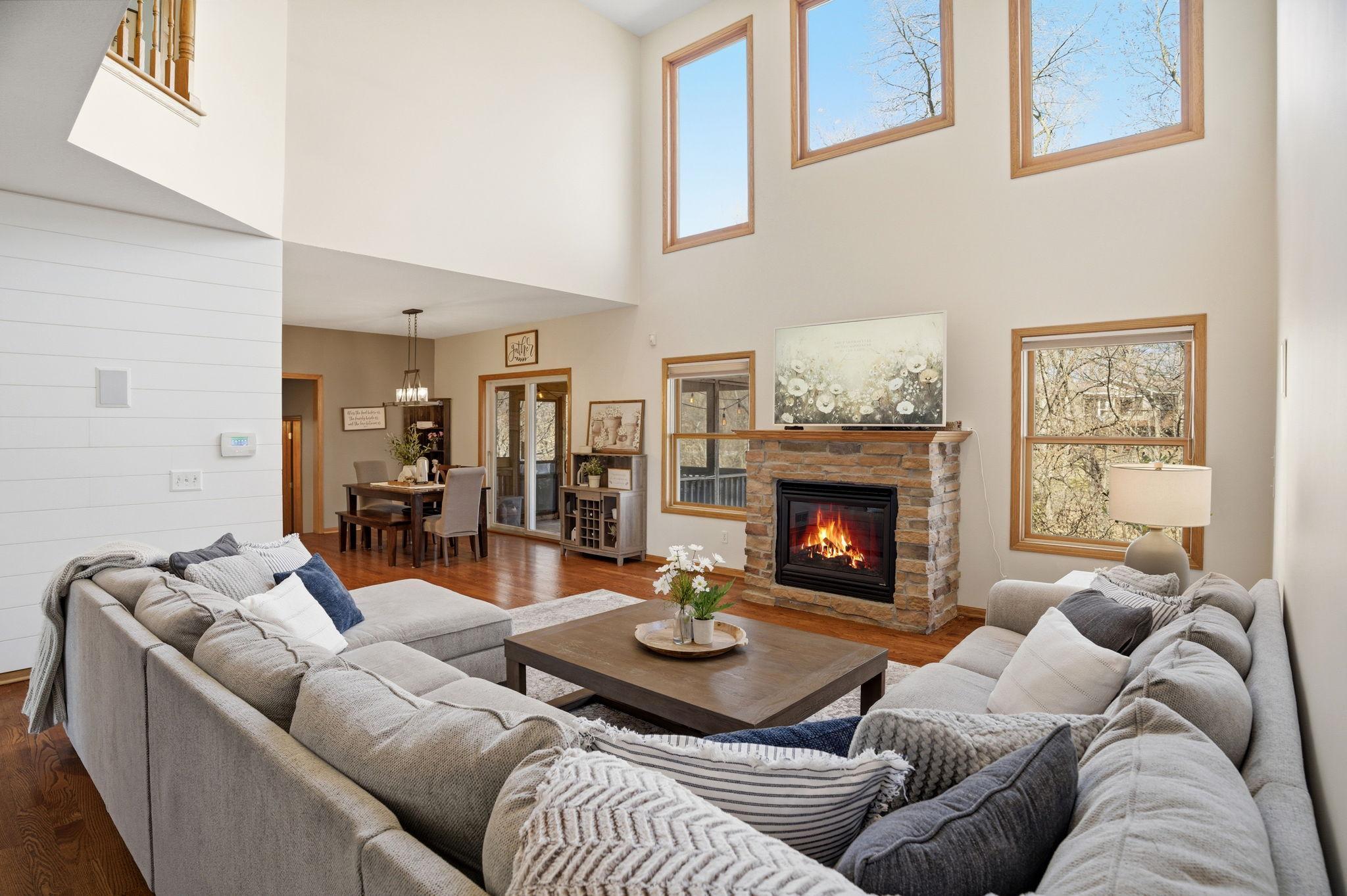 Large two-story family room that opens to the dining area and three-season porch, with a beautiful view from the second floor into the great room.