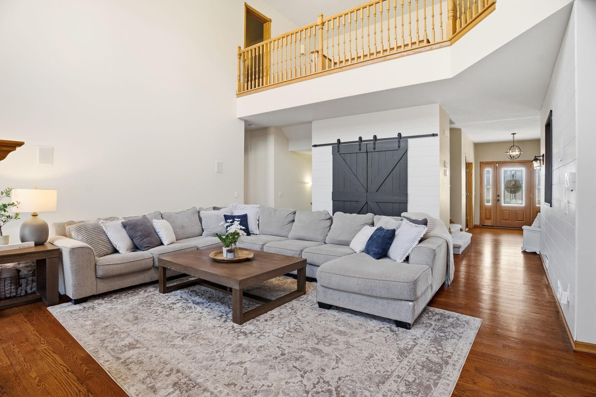 Stylish barn doors in the great room conceal a versatile closet, perfect for extra blankets, games, and electronics.