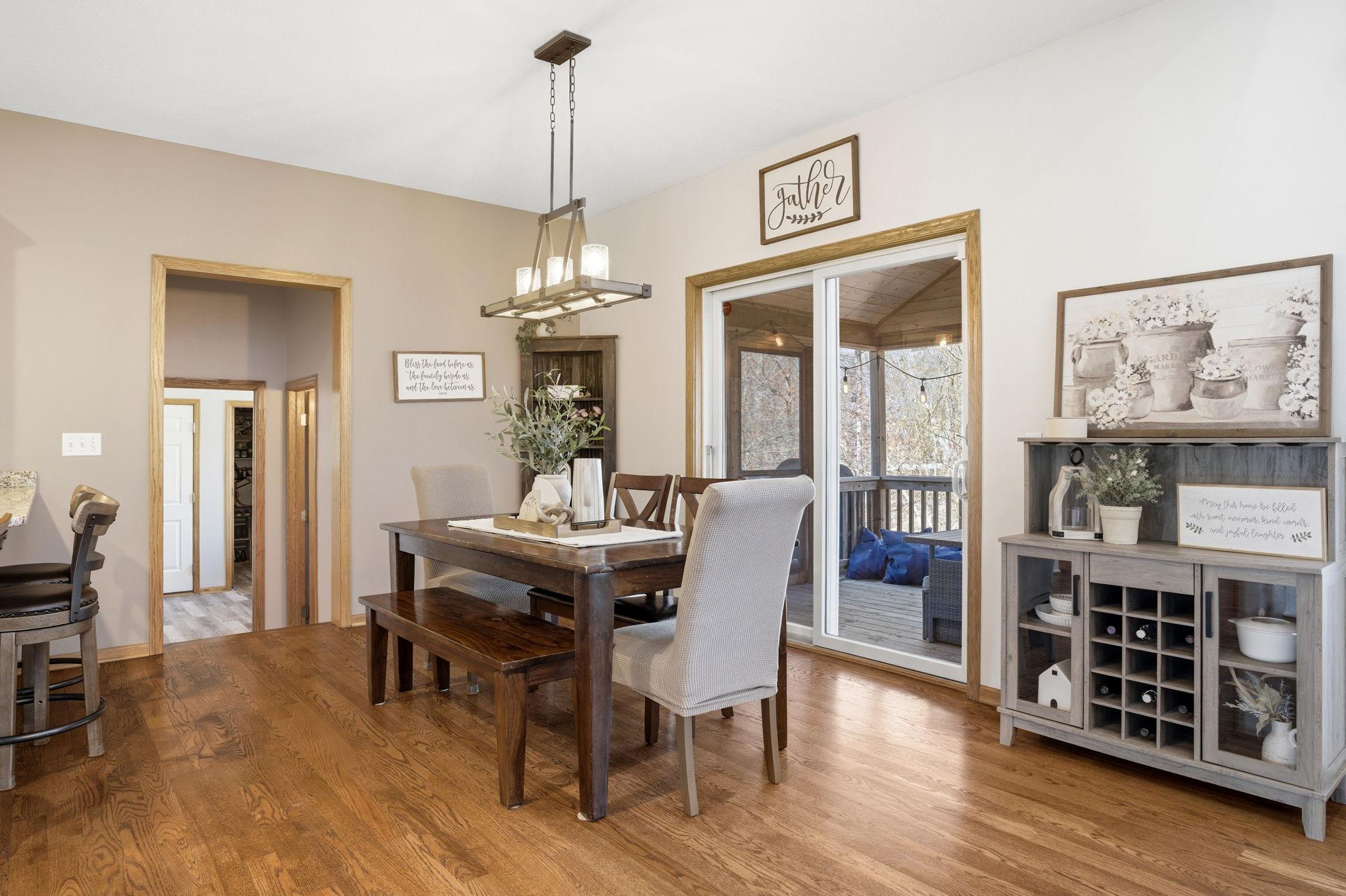 The dining room flows into the three-season porch, while a nearby hallway leads to the half bath, mudroom/laundry room, storage closet and 3 stall garage.