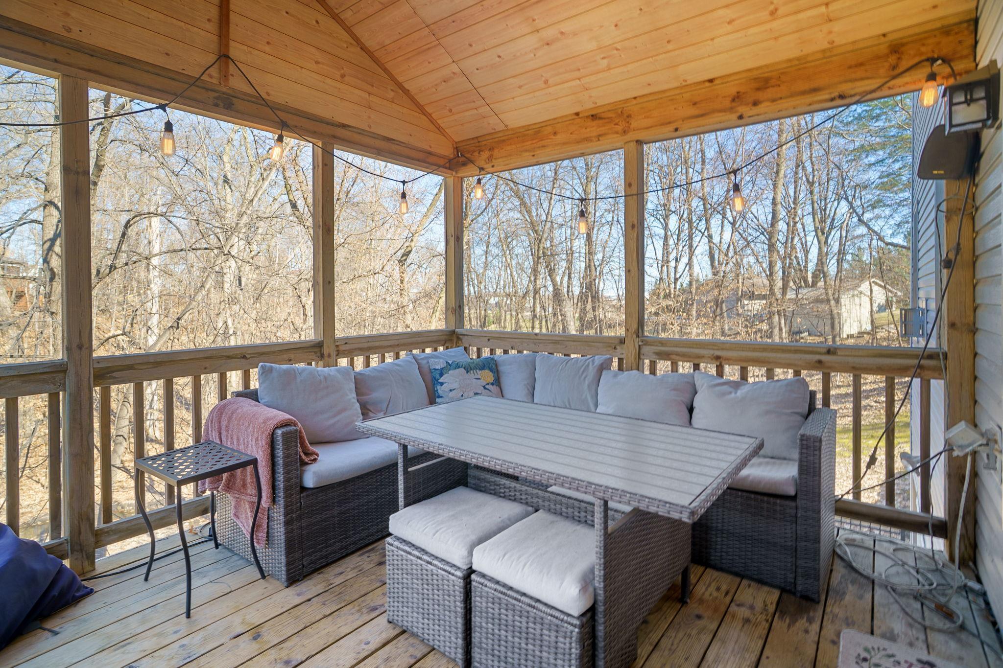 Inviting three-season porch accessible from the dining room, offering seamless indoor-outdoor living.