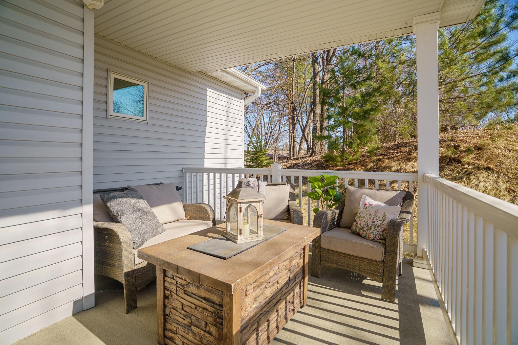 Expansive front porch stretching across the entire front of the home, adding charm and functional outdoor living space.