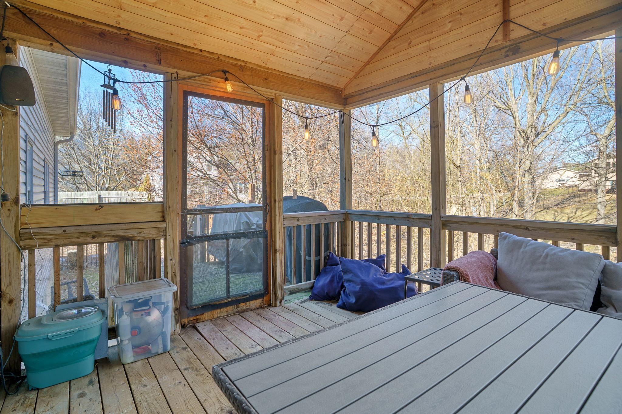 Inviting three-season porch accessible from the dining room, offering seamless indoor-outdoor living.