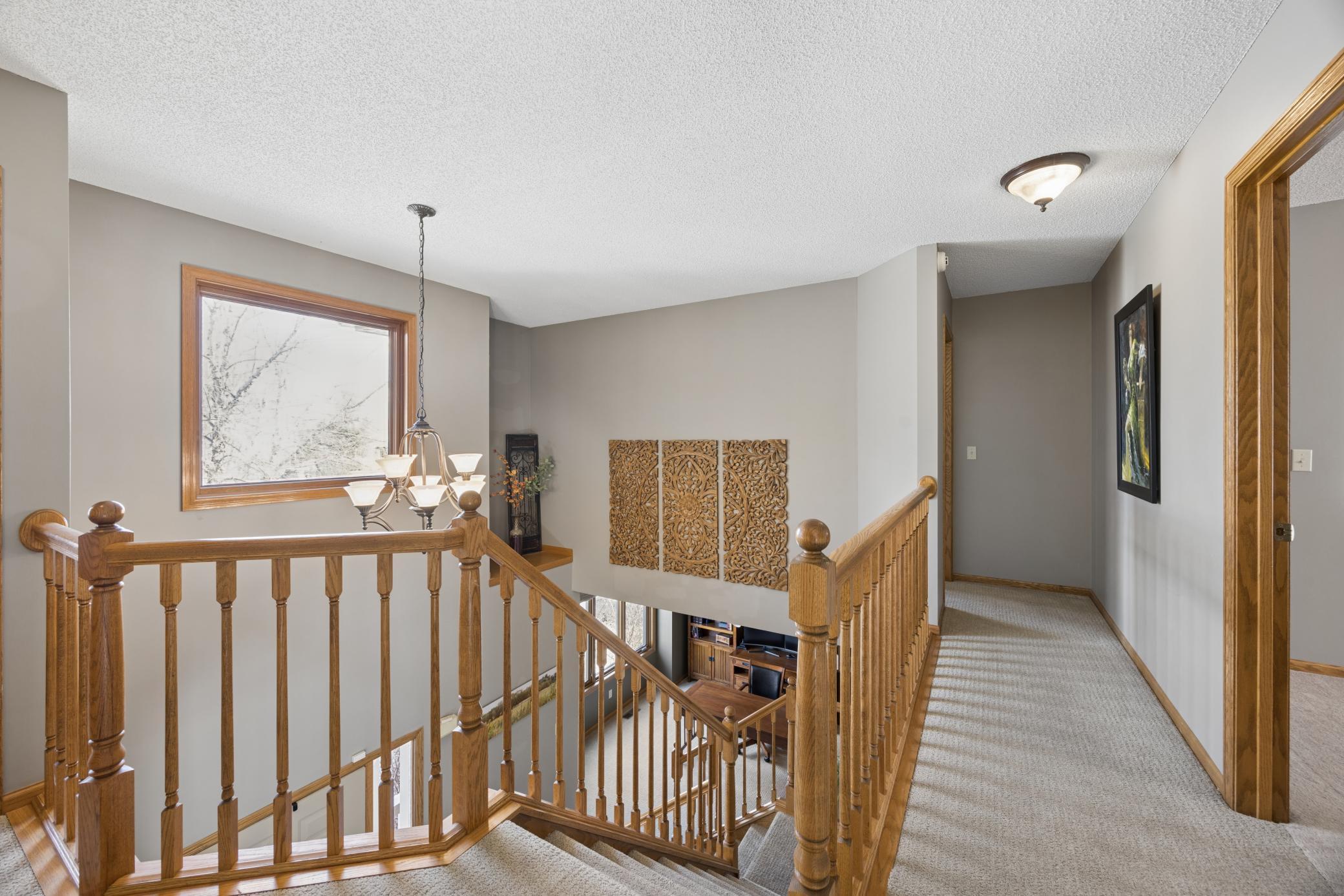 Upstairs landing area overlooks the two story foyer