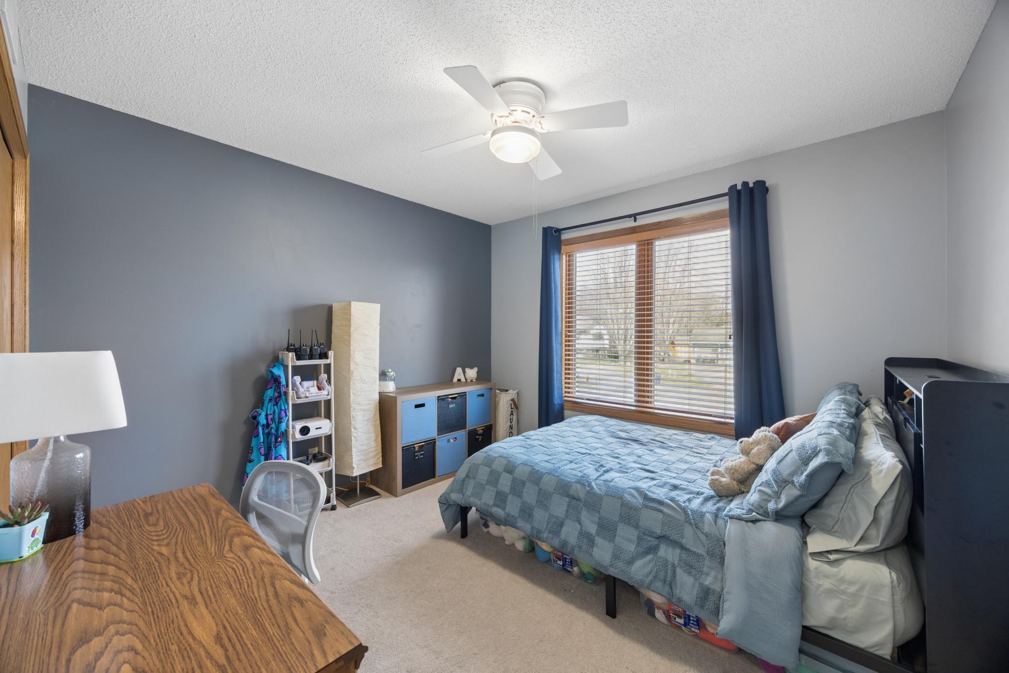 Third of three bedroom upstairs has custom built shelving in the closet
