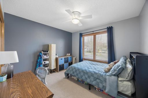 Third of three bedroom upstairs has custom built shelving in the closet