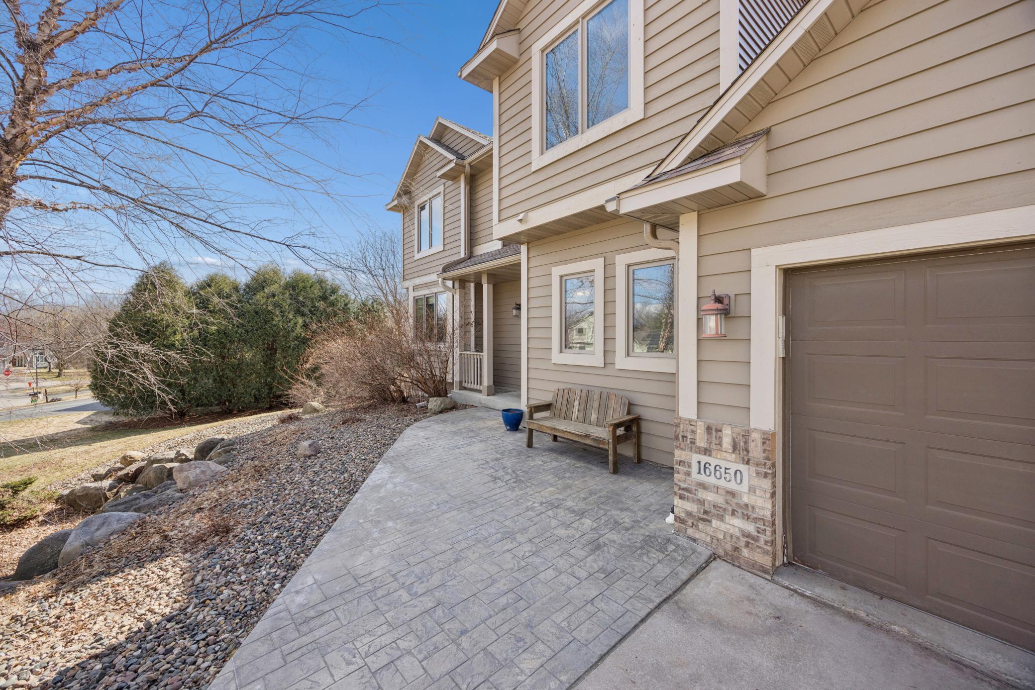 The front paver patio and charming covered porch create a warm first impression as you arrive