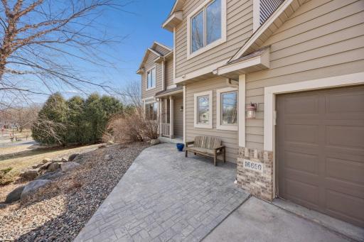 The front paver patio and charming covered porch create a warm first impression as you arrive