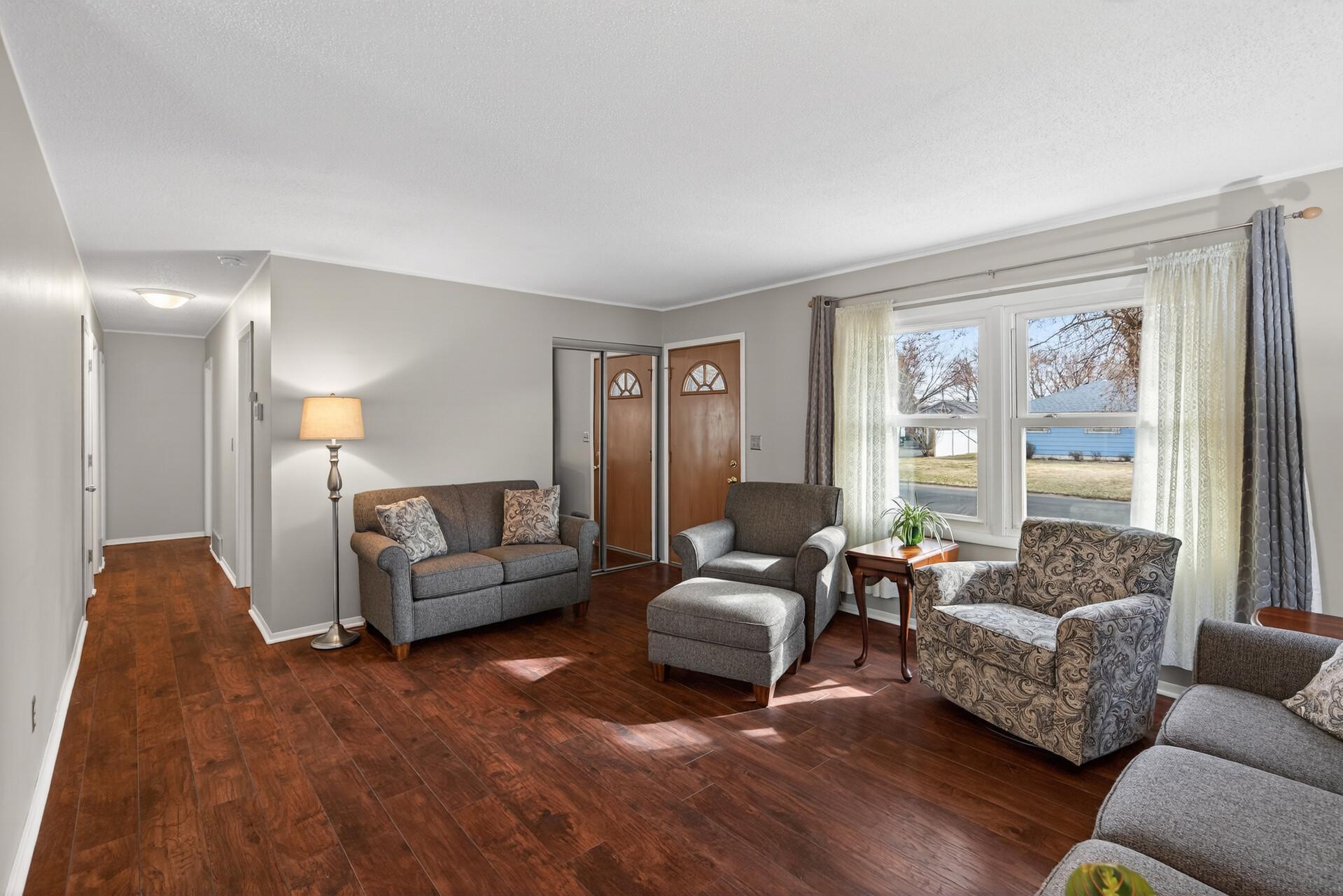 The living room and hallways feature durable luxury vinyl flooring.
