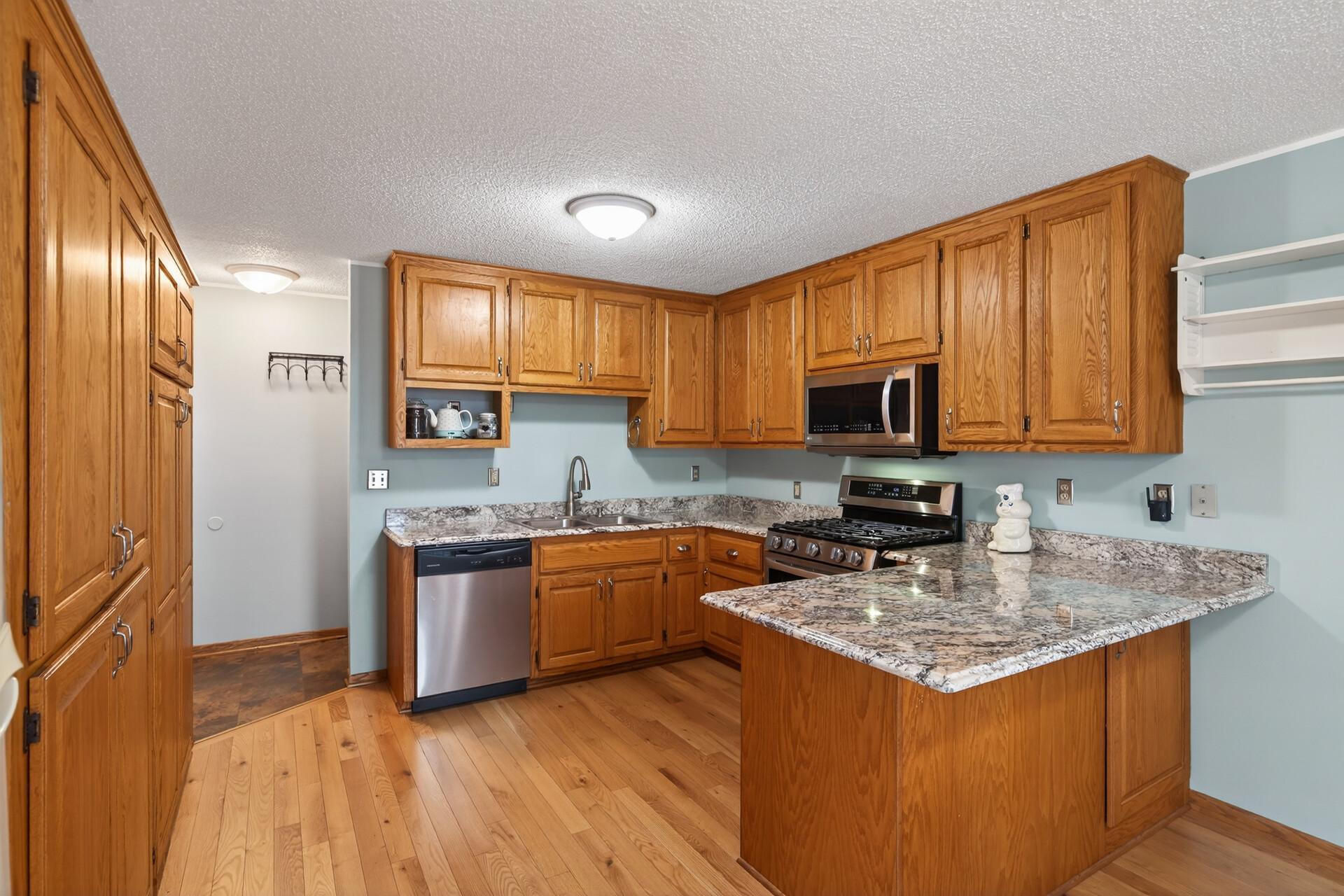 Bright, open kitchen with tons of cabinet storage and granite countertops, perfect for everyday living and entertaining.