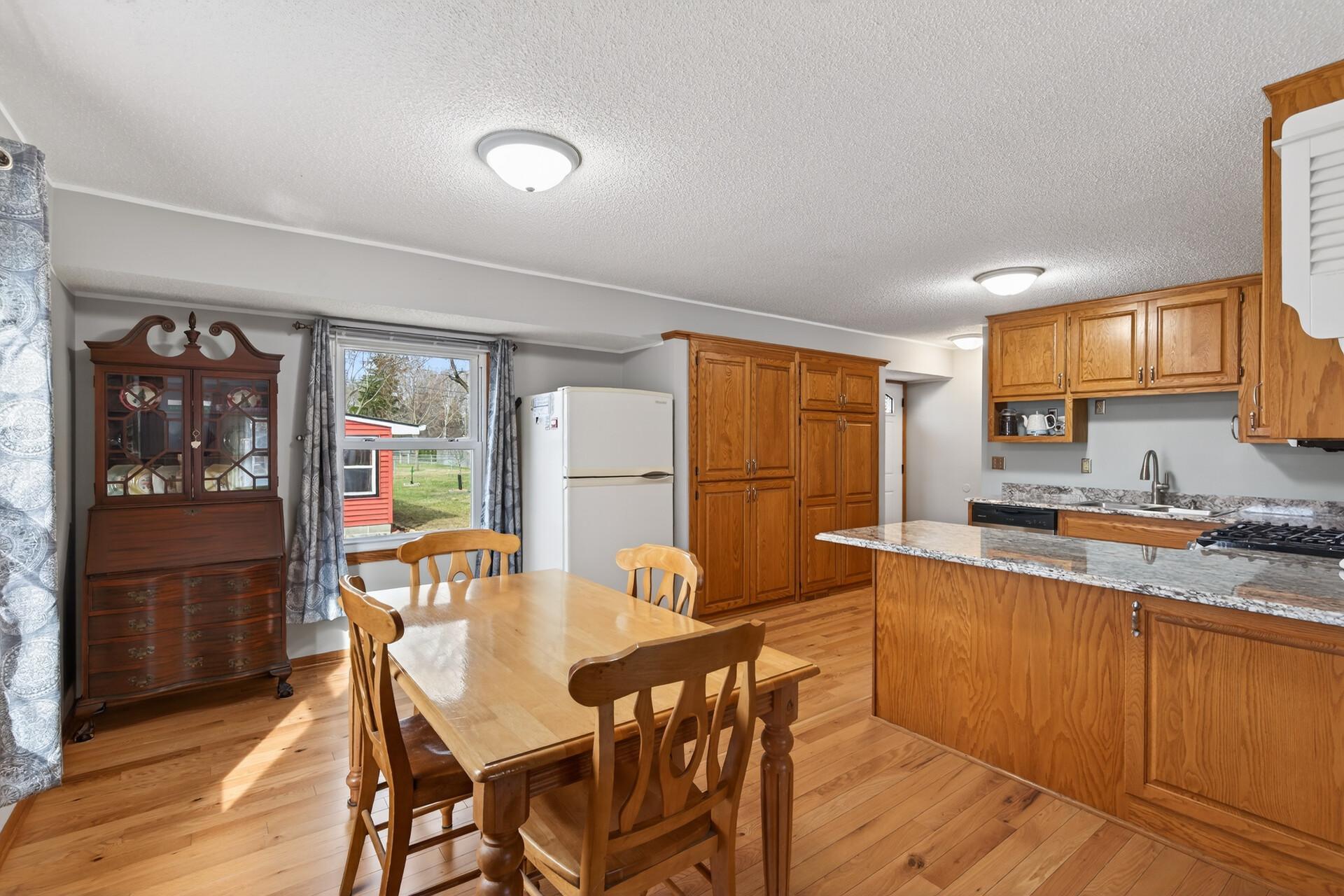 Dining area with sightlines into the kitchen and out to the backyard, giving it a bright, open feel.