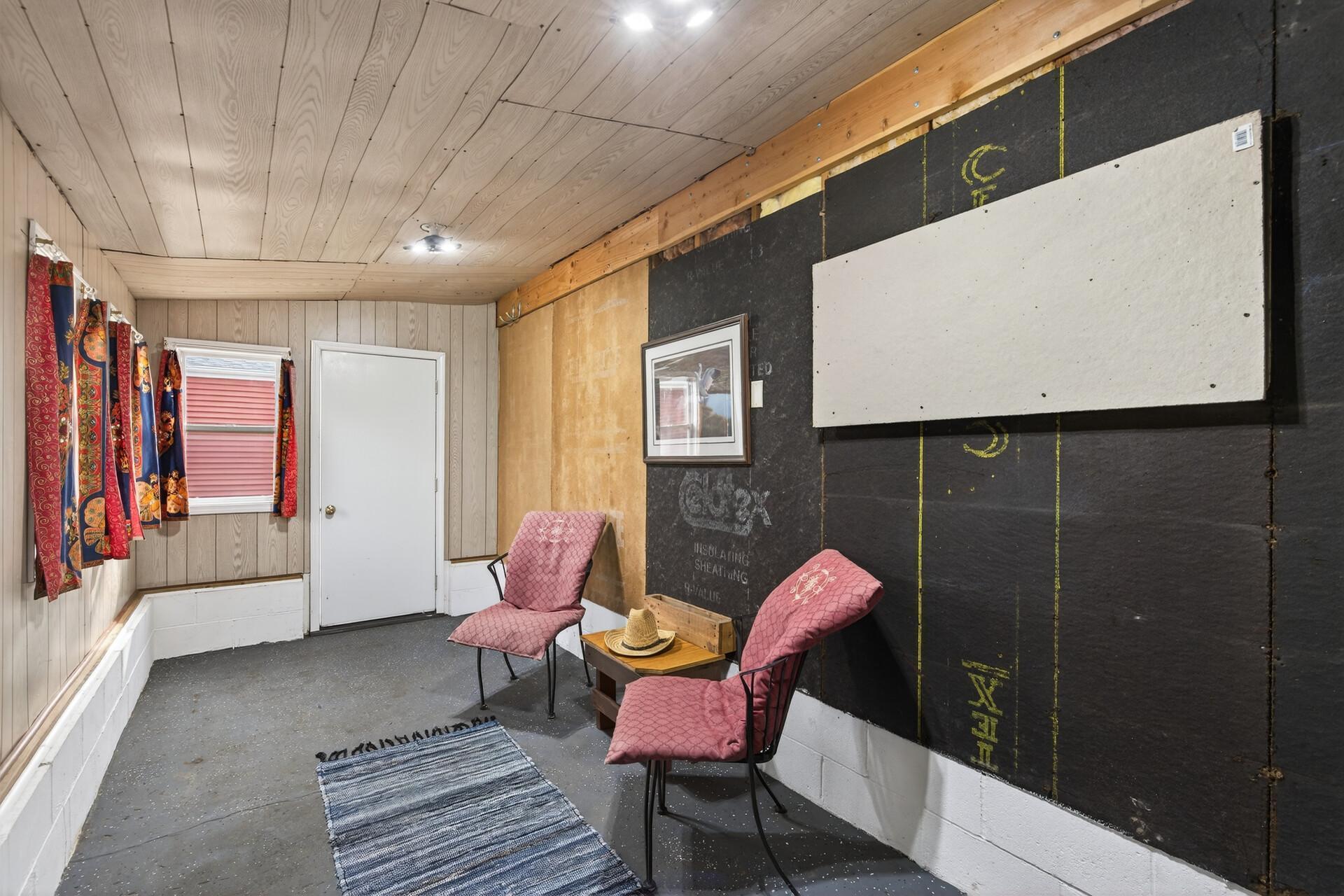 Covered and heated lean-to that works well as a sitting area or added storage space.