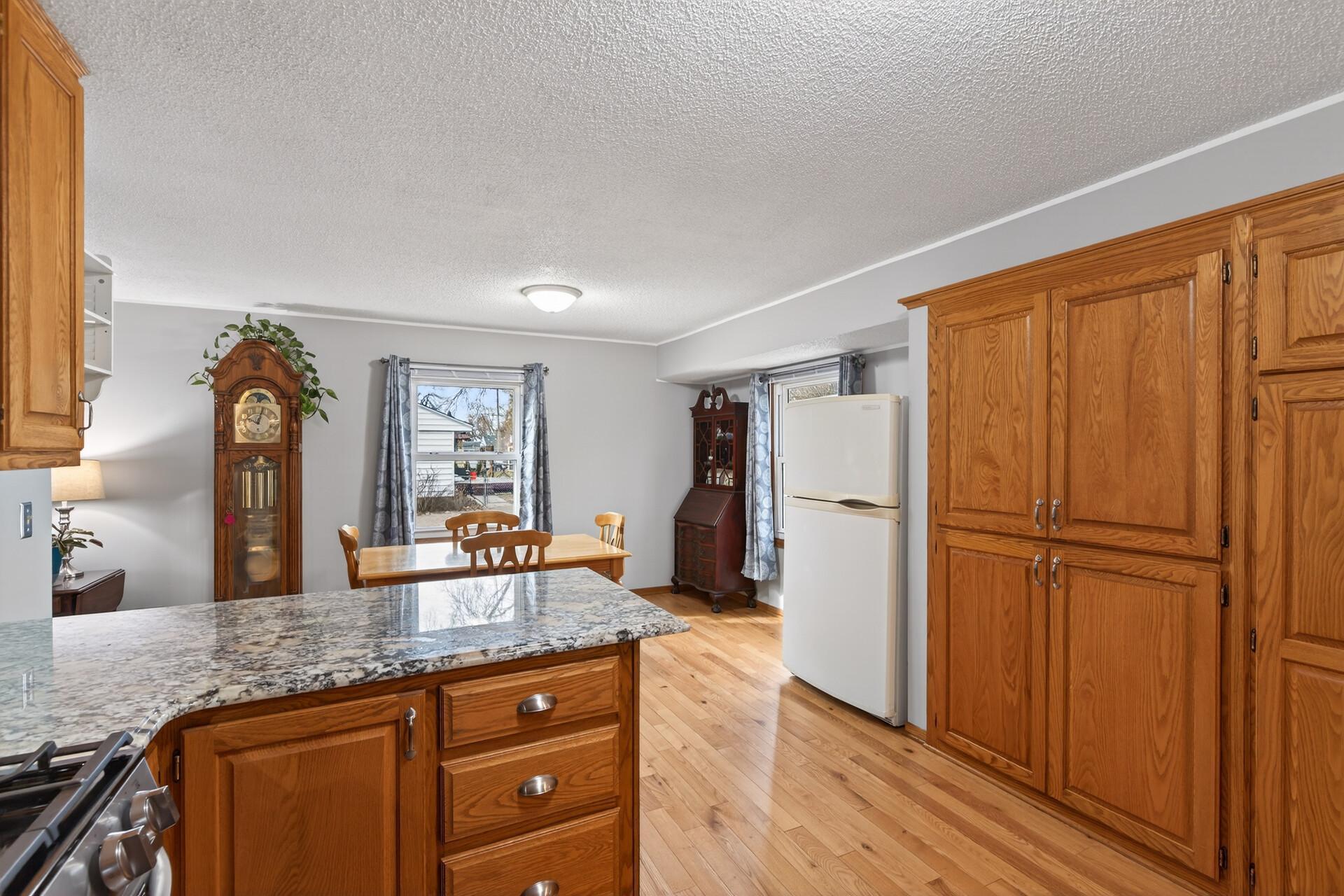Spacious open kitchen loaded with cabinet space and finished with granite countertops, making it both functional and easy to enjoy.