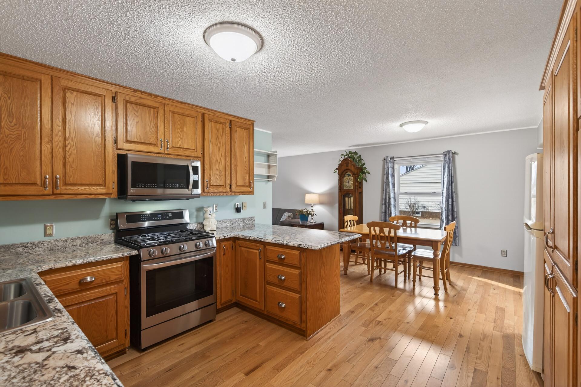 Open kitchen with plenty of cabinet space and granite countertops, giving you room to cook, host, and actually enjoy the space.