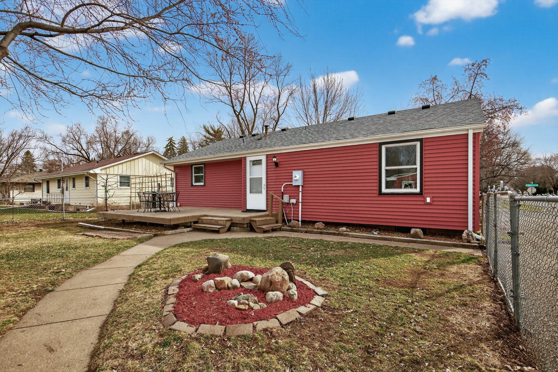 Walk-out rear deck with views of the spacious yard.