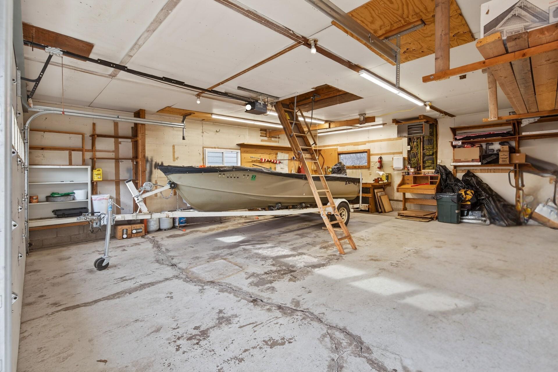 Spacious oversized heated garage with extra storage space above.