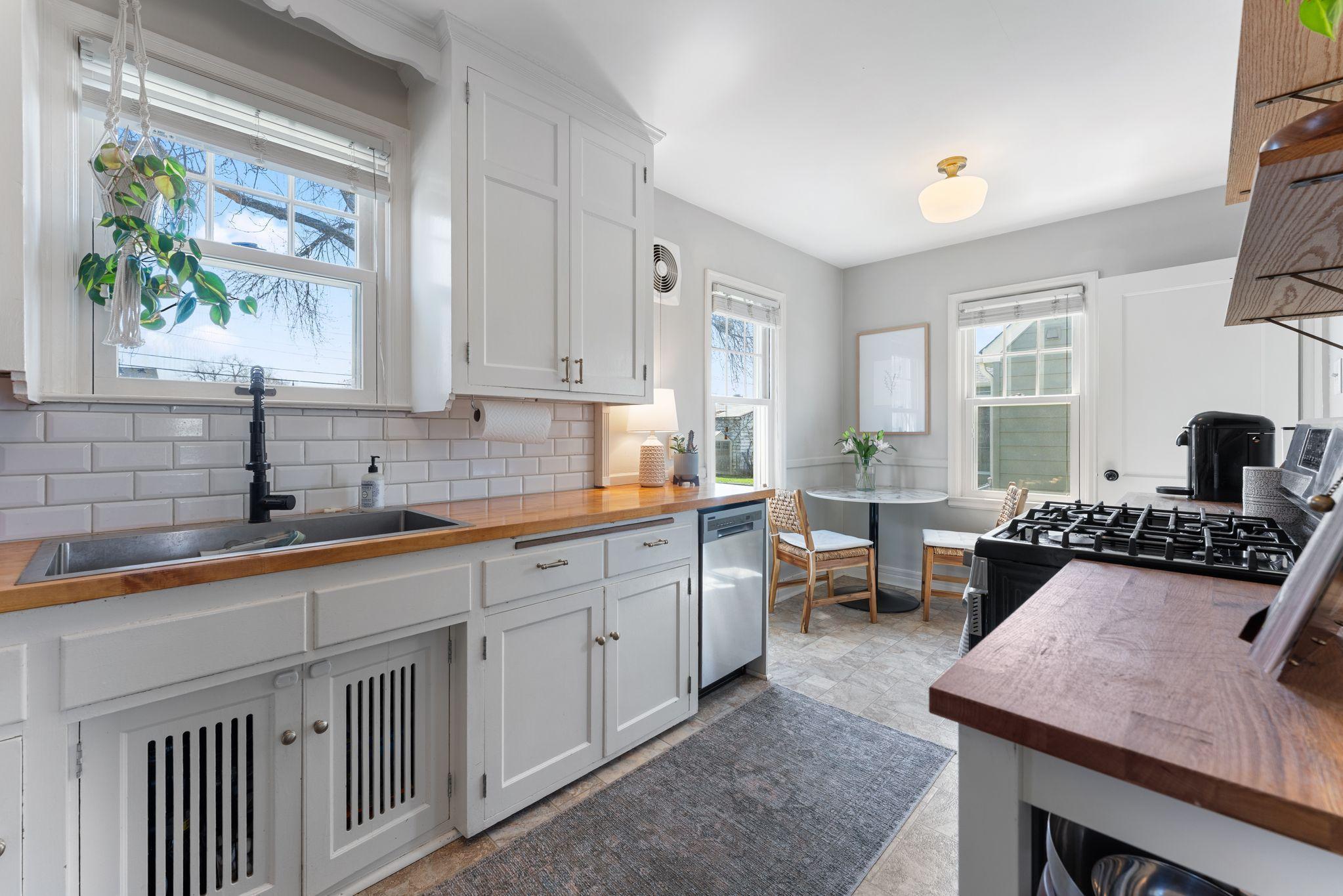 The kitchen has been nicely updated with enameled cabinets, stainless steel appliances and butcher block countertops.