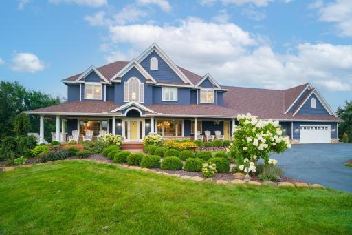 Photo for 3050 Becker Road, Maple Plain, MN 55359 - listing #7041911 A picture-perfect home featuring a welcoming wraparound porch, vibrant landscaping, and timeless curb appeal.