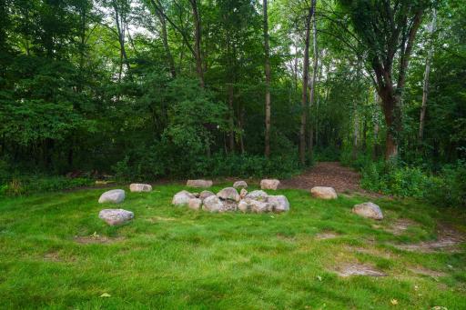 Fire pit and trail access through private woods. Find your way to the knoll - a perfect spot for a future reading clubhouse or a picnic.