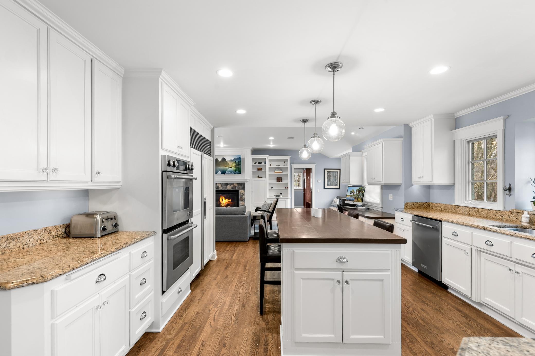 Kitchen continues with the hard wood floors and stainless appliances