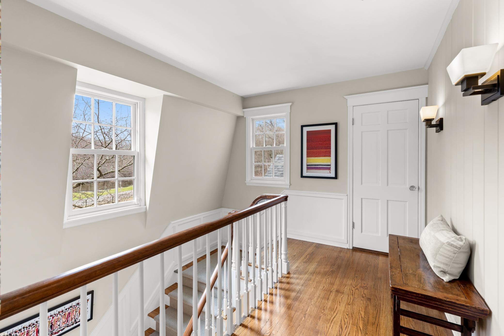 Stairway gracefully leads to second floor bedrooms [4 in the upper level]