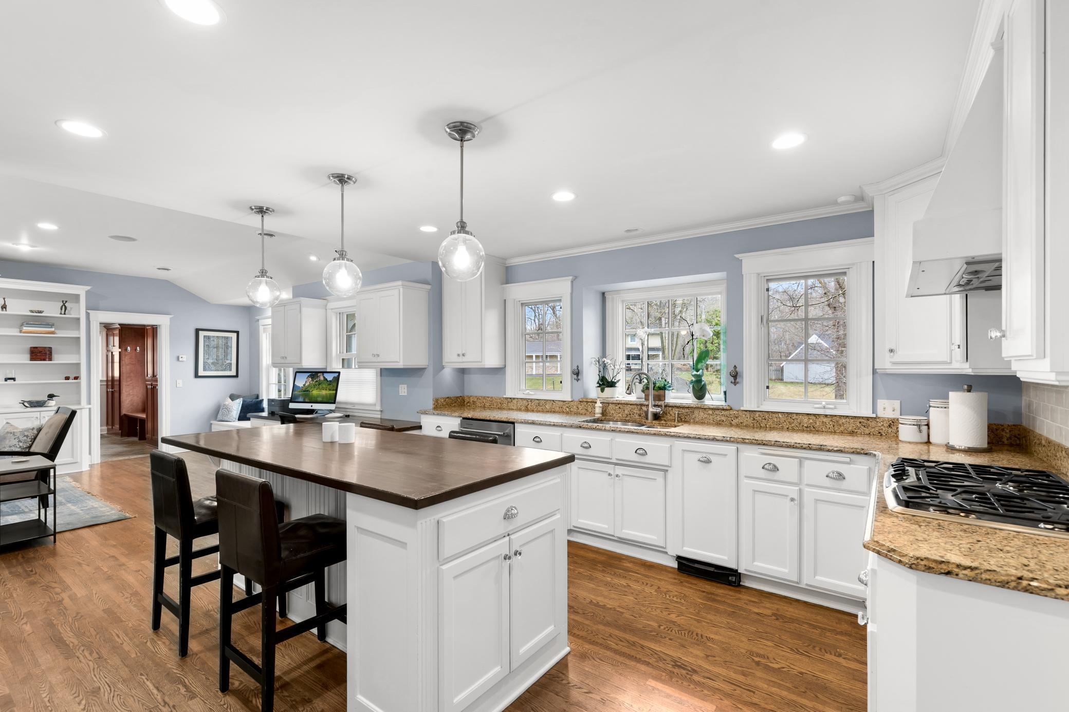 South facing light floods into the bright kitchen complimenting the natural stone and wood finishes