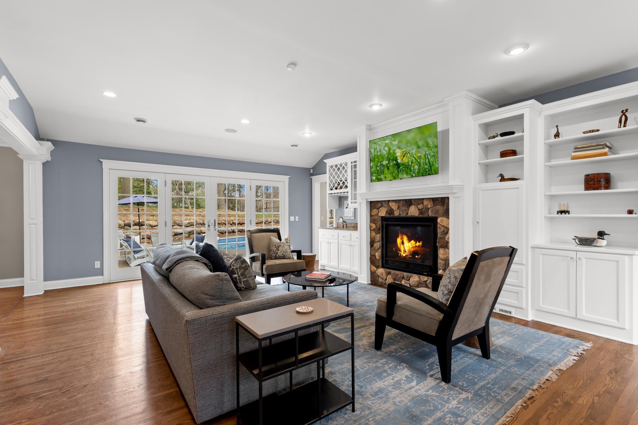 Family room with generous light into the back yard - warmth surrounds with fireplace and built-in cabinetry