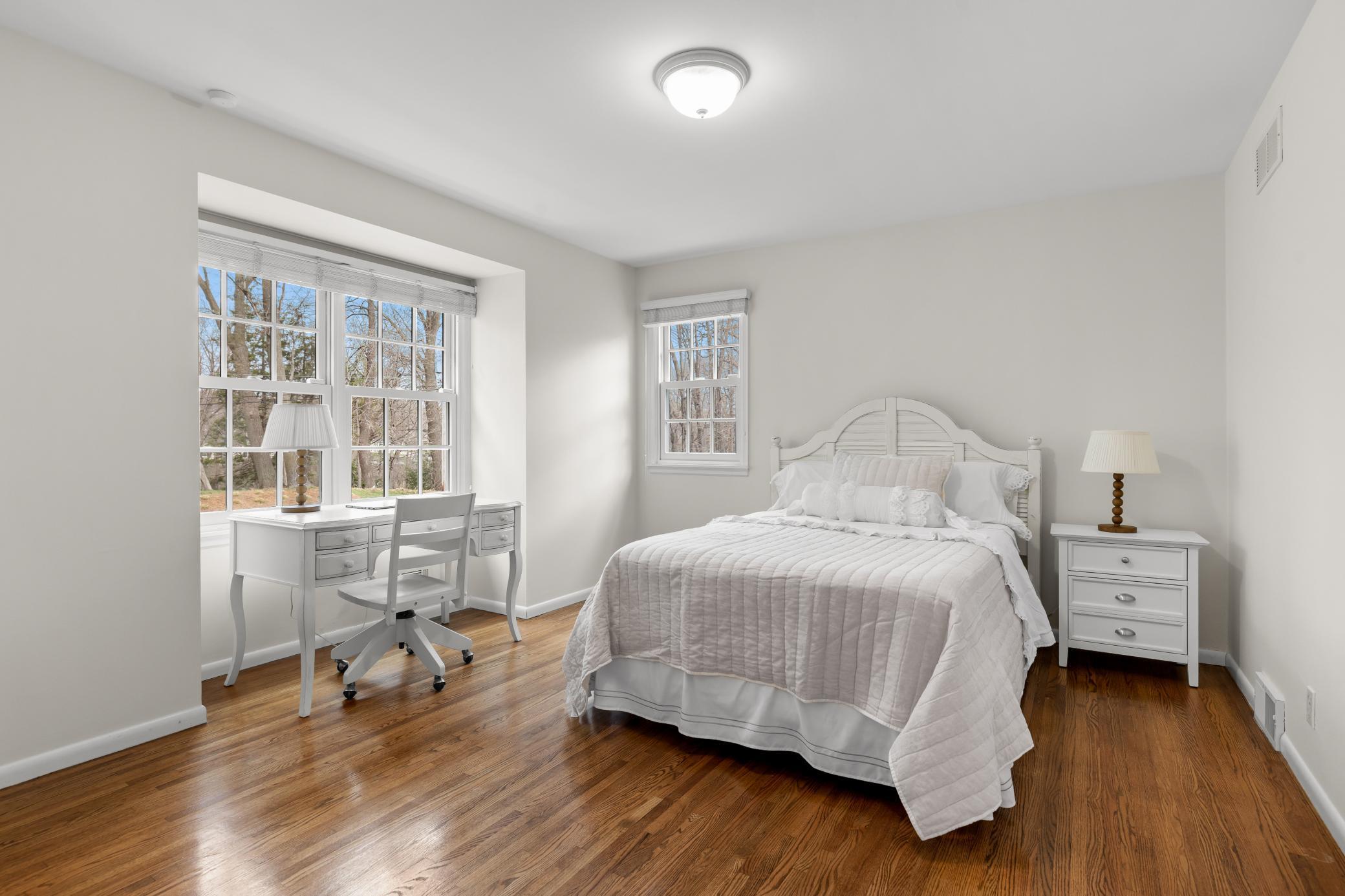Second level bedroom with natural light from beautiful windows