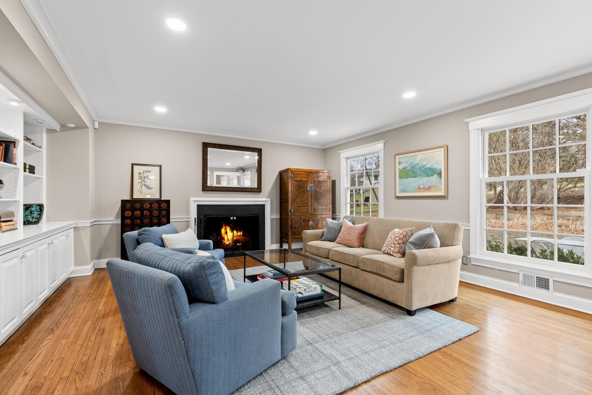 Formal living room/library with gleaming hardwood floors