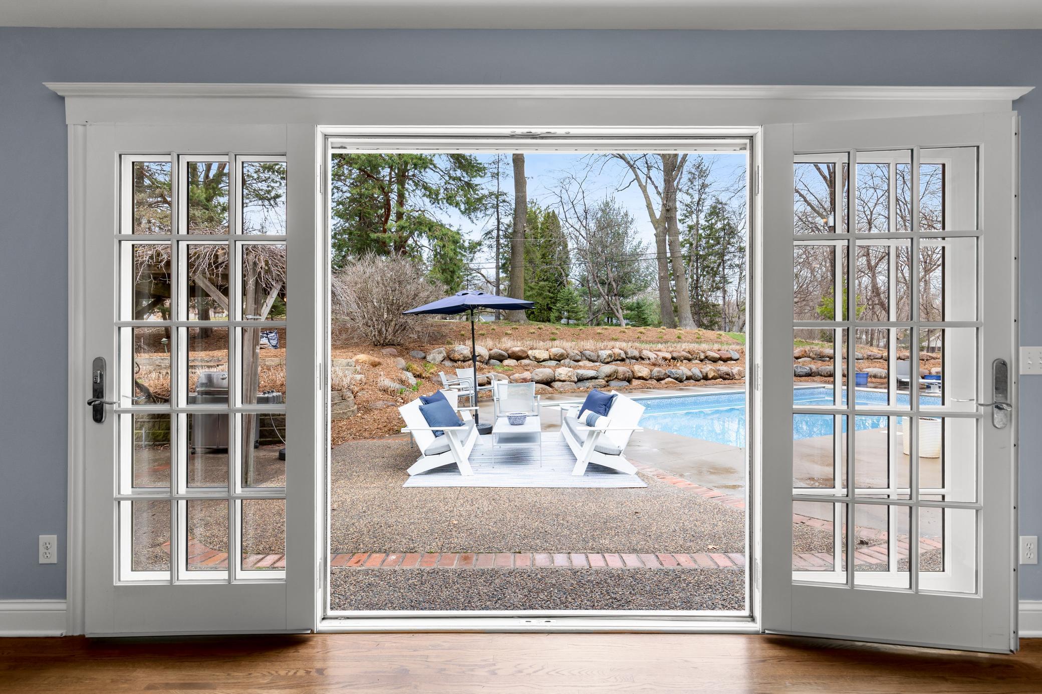 French doors open from family room to back yard pool/patio/mature gardens