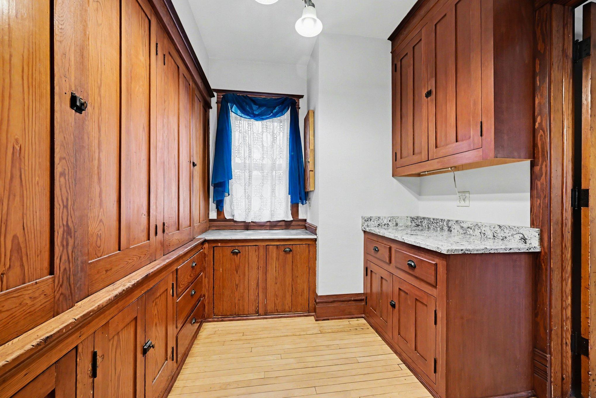 Convenient butler's pantry with a granite counter top