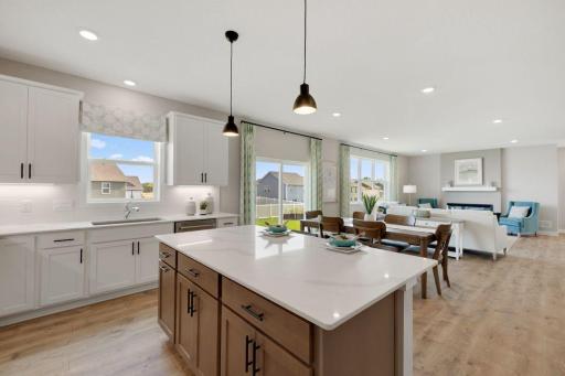 View from the kitchen to your open concept main floor with your informal eating area, and spacious family room. (Photos of model, options may vary).
