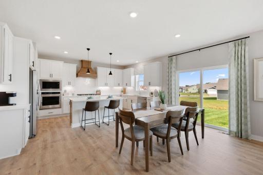 View of the informal eating area flooded with light located between the family room and kitchen. Photos of model, options may vary.