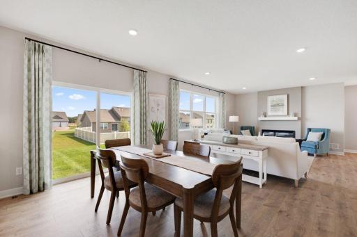 The sliding glass door located off the informal eating area makes the main floor feel bright and open and makes it convenient to add a future deck. Photos of model, options may vary.