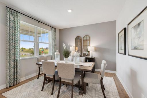 The formal dining room is perfect for entertaining, hosting, and allows space for everyone to sit and enjoy a delicious meal. Photos of model, options may vary.
