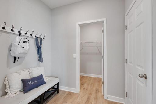 Conveniently located mud room with spacious walk in closet is perfect for storing all that winter gear. Photos of model, options may vary.