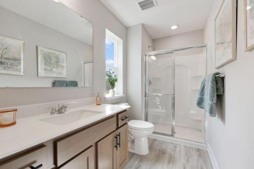 Private bath located in bedroom 2. Photos of model, options may vary.