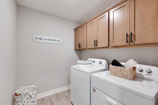 Conveniently located upstairs laundry with optional cabinets shown. Photos of model, options may vary.