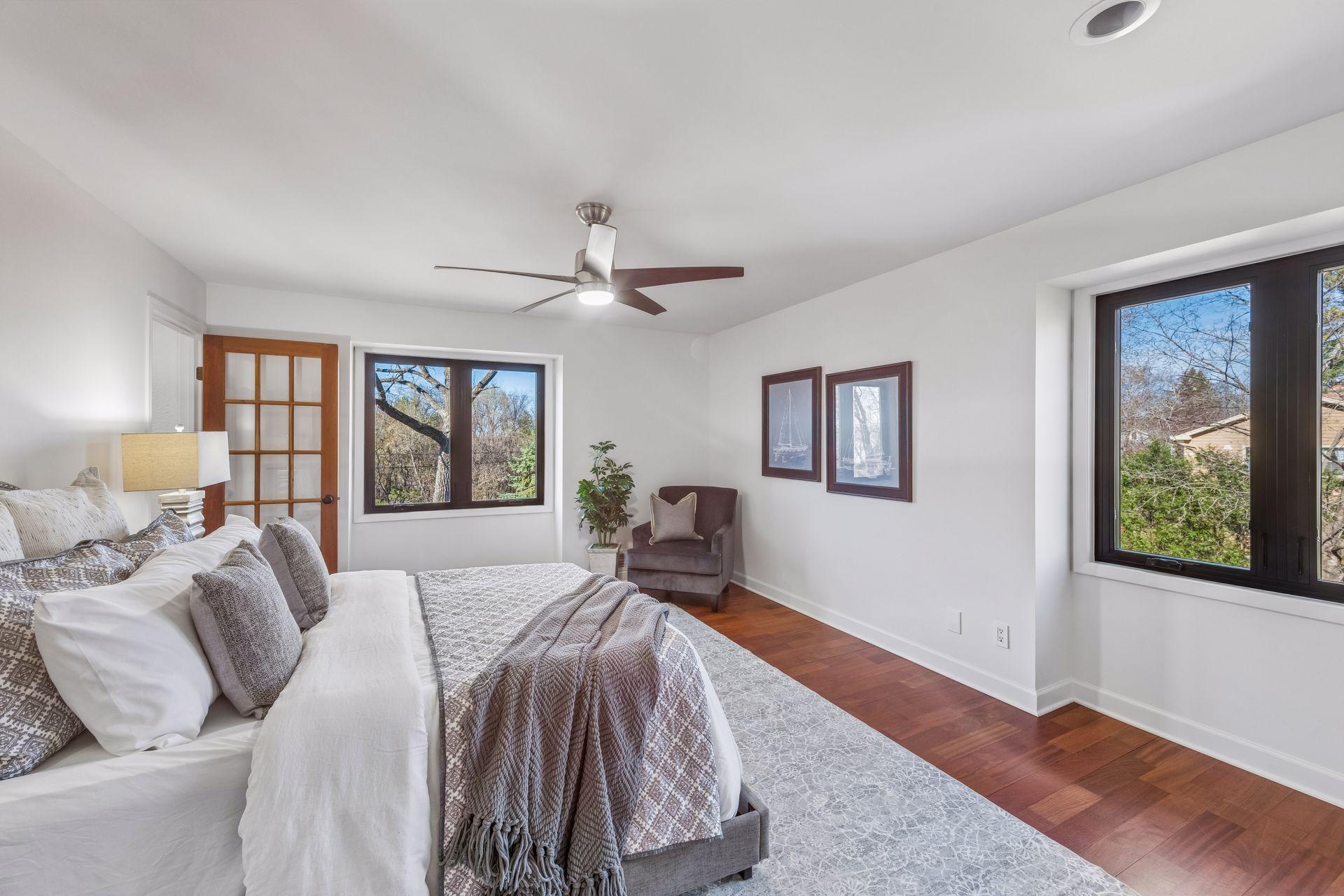 Spacious primary suite with seasonal lake views is a serene oasis