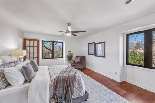 Spacious primary suite with seasonal lake views is a serene oasis
