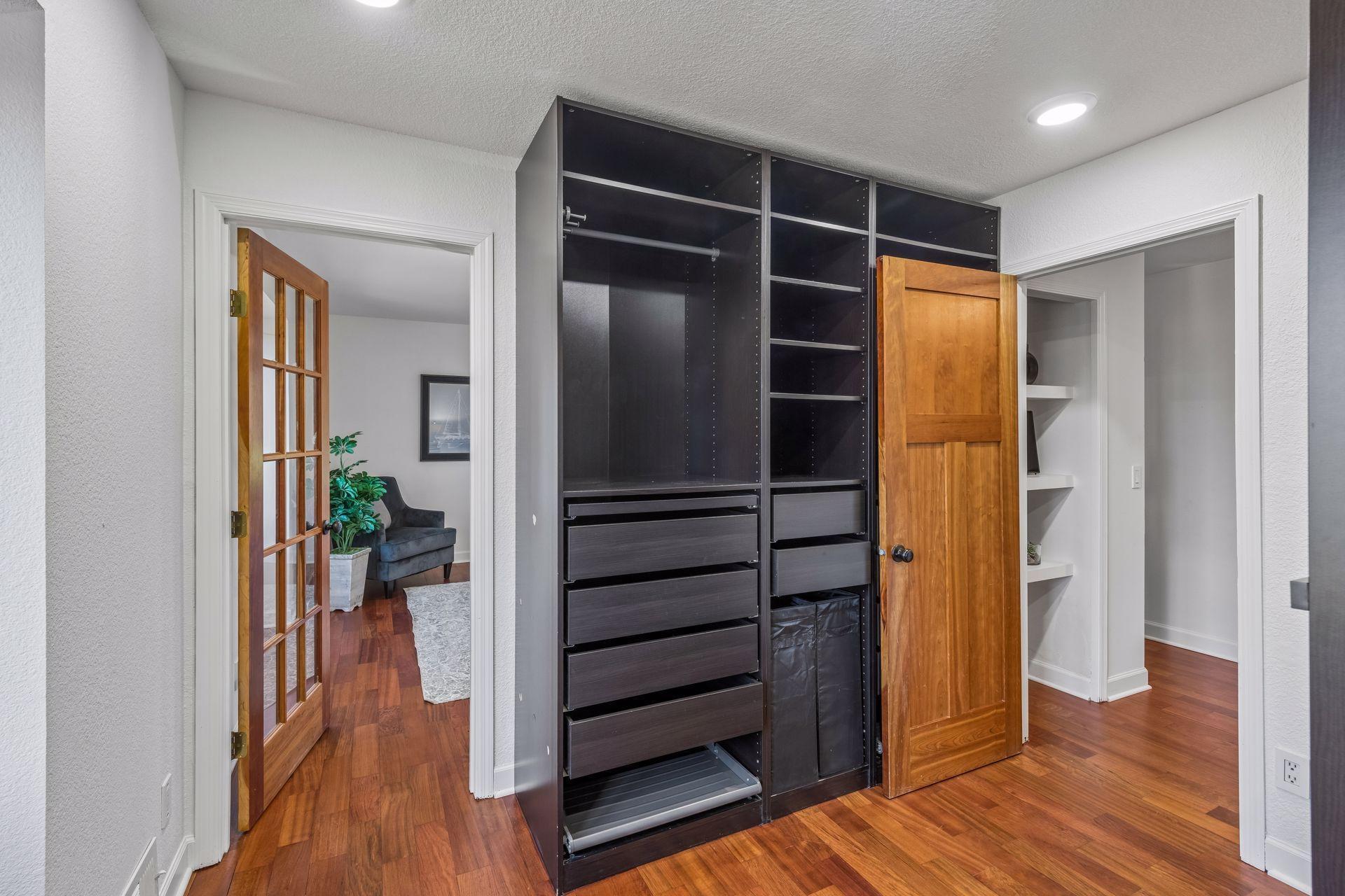 The large primary closet with built-ins has convenient access from the primary bedroom and hallway.