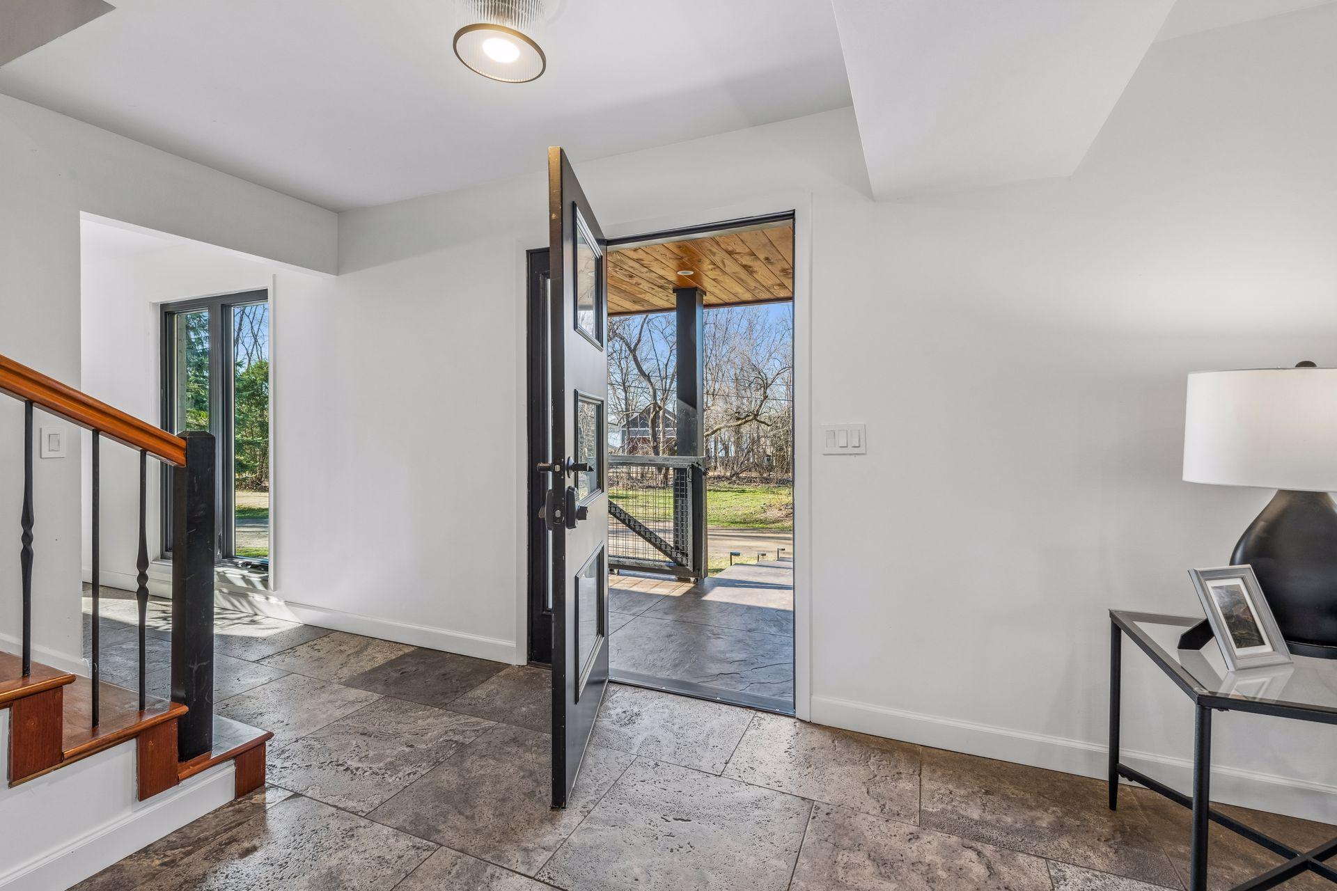 Welcoming covered front porch and new front door welcome you inside