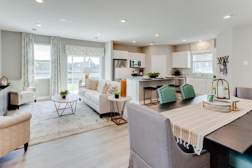 Different angle of the living room and kitchen. *Photos are of a previously staged model*